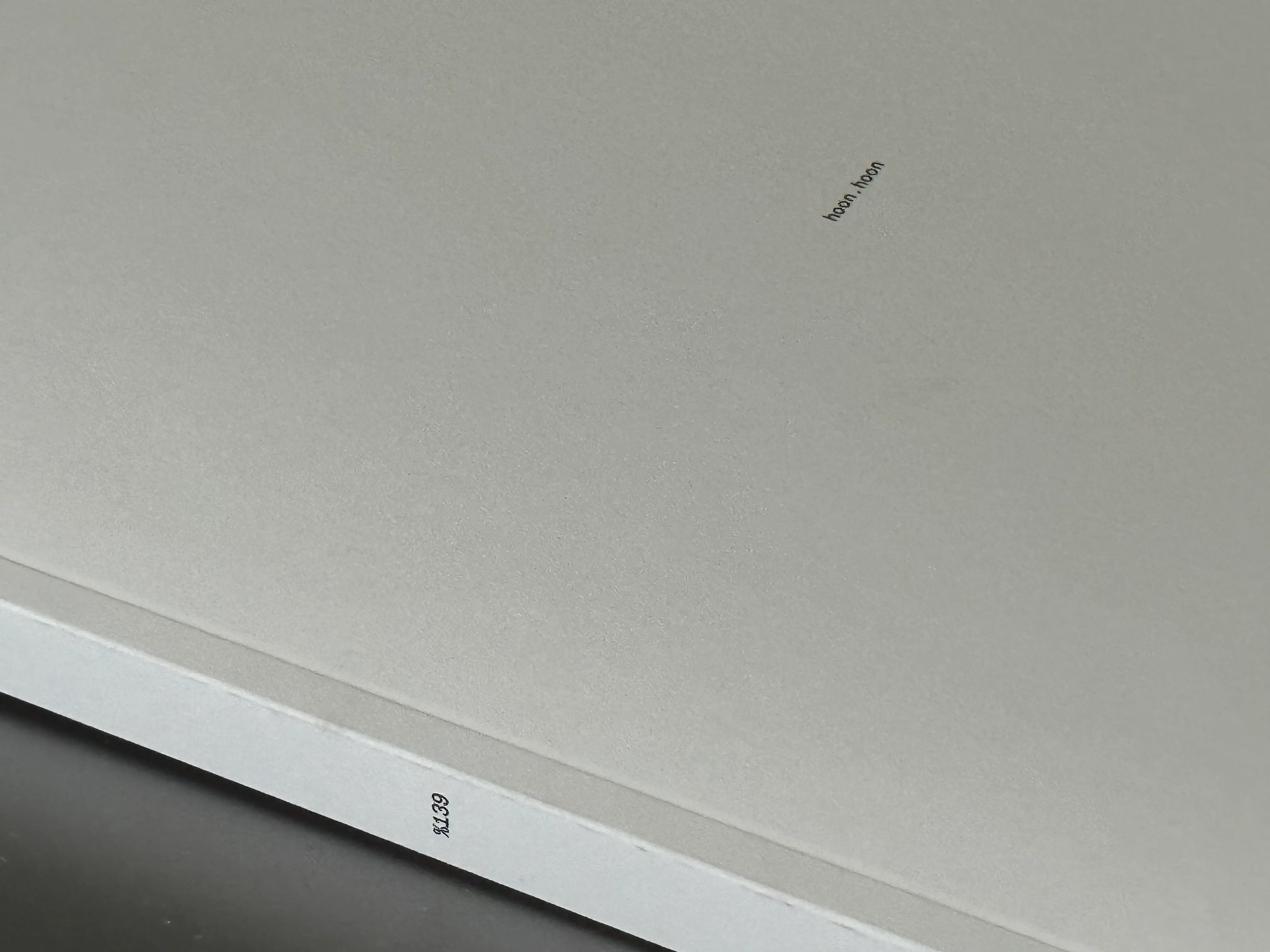 A light-dappled textbook cover titled ‘hoon.hoon’, text on book spine states ‘$139’.